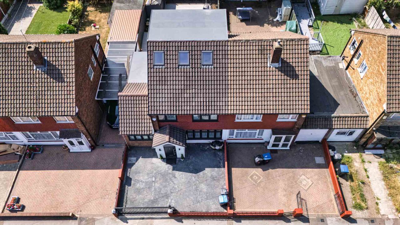 Drone view of a house roof with a rear roof extension and roof windows